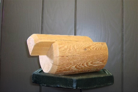 Machine-peeled house logs with precision half-round ripping for structural and aesthetic applications.